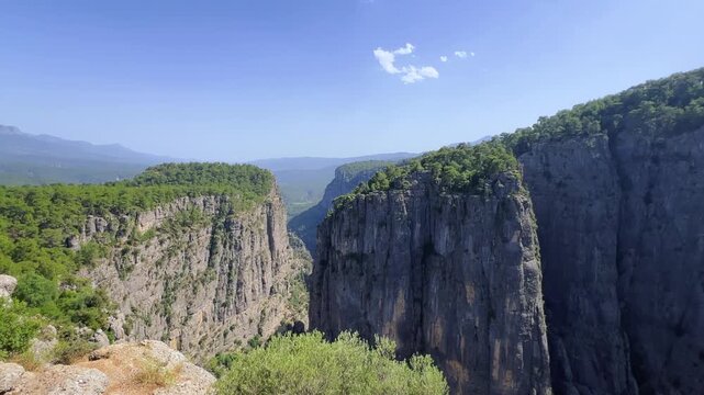 A mountain valley landscape with forests and cliffs. Huge rocks and rocky outcrops. A beautiful deep canyon with lots of tourists. A bird's-eye view of the Tasi Canyon. T&uuml;rkiye	