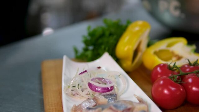 Close-up of female hands of a cook preparing a salad of salted herring with green onions and shallots. High quality 4k footage