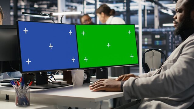 Data center software developer inspecting gear using isolated screen PC, doing maintenance tasks. Server room IT specialist using mockup computer, conducting system checks, close up - Powered by Adobe