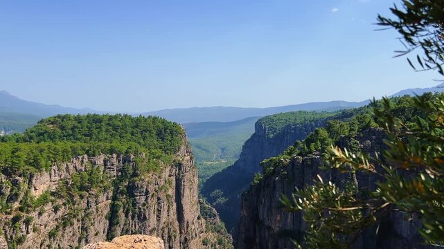 A mountain valley landscape with forests and cliffs. Huge rocks and rocky outcrops. A beautiful deep canyon with lots of tourists. A bird's-eye view of the Tasi Canyon. T&uuml;rkiye