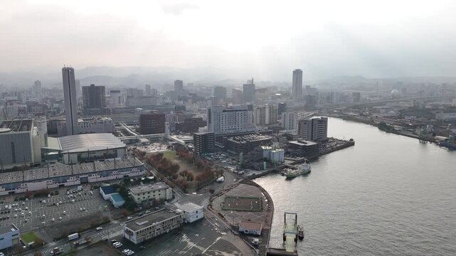 Kitakyushu City, Fukuoka Prefecture, Kyushu, Japan: 4K Aerial Drone Footage of Waterfront Skyline, Urban Districts, High-Rise Buildings, Skylines and Mists Over Mountains
