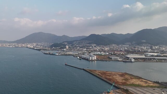 Kitakyushu City, Fukuoka Prefecture, Kyushu, Japan: 4K Aerial Drone Footage of Waterfront Skyline, Urban Districts, High-Rise Buildings, Skylines and Mists Over Mountains