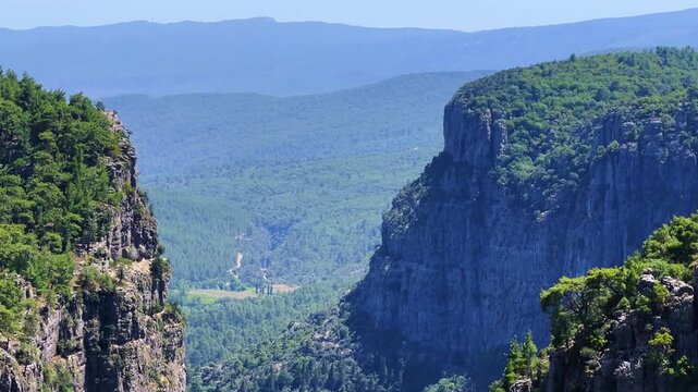 A mountain valley landscape with forests and cliffs. Huge rocks and rocky outcrops. A beautiful deep canyon with lots of tourists. A bird's-eye view of the Tasi Canyon. T&uuml;rkiye	