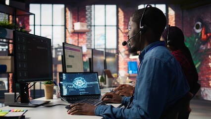 Call center worker in office using AI chatbot to answer customer questions. Man doing customer...