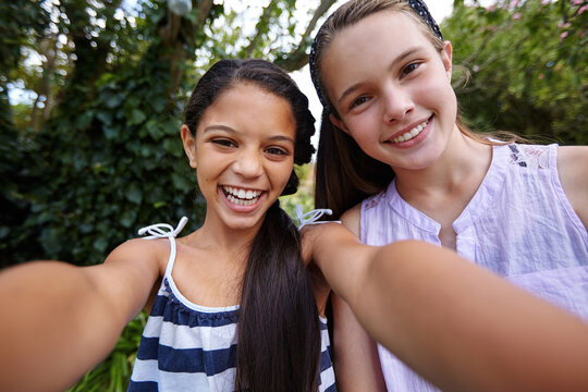 Happy girl, portrait and teenager friends with selfie for photography or outdoor fun together. Children, youth or POV with smile for picture, capture moment or social media in backyard or garden - Powered by Adobe