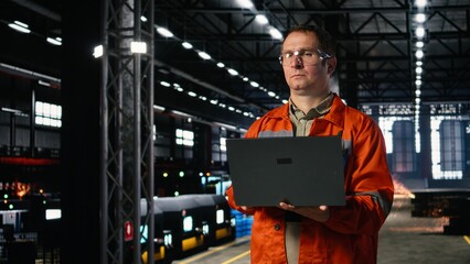 Industrial worker wearing safety glasses adjusts machinery in a warehouse, demonstrating production...