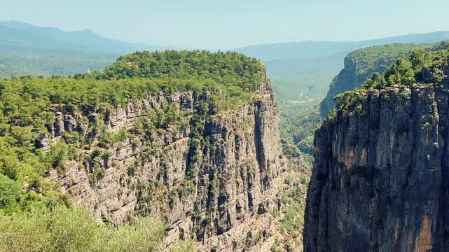 A mountain valley landscape with forests and cliffs. Huge rocks and rocky outcrops. A beautiful deep canyon with lots of tourists. A bird's-eye view of the Tasi Canyon. T&uuml;rkiye	