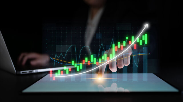 A professional setting showcases a hand interacting with a digital graph representing business growth, emphasizing technology in financial analysis and decision-making. Impute