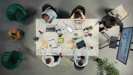 Top down view of diverse colleagues and managers participating in briefing. Business meeting...