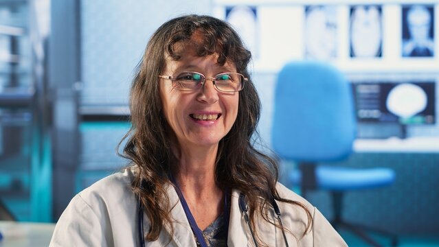 Woman medic examining a male patient in office for routine checkup, discussing about treatment plan for recovery at the clinic. Expert provides healthcare services on insurance. Camera B.