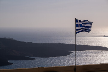 Greek Flag and Nea Kameni at Sunset