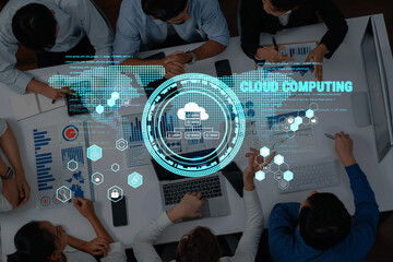 A diverse group of professionals collaborates in a modern workspace, analyzing data and discussing cloud computing concepts, enhanced by digital icons and graphs. Trope