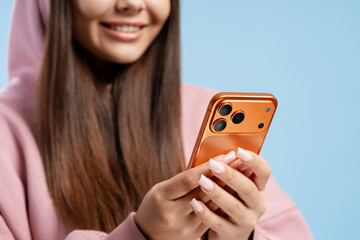 Young woman smiling, texting on smartphone, engaging in digital communication