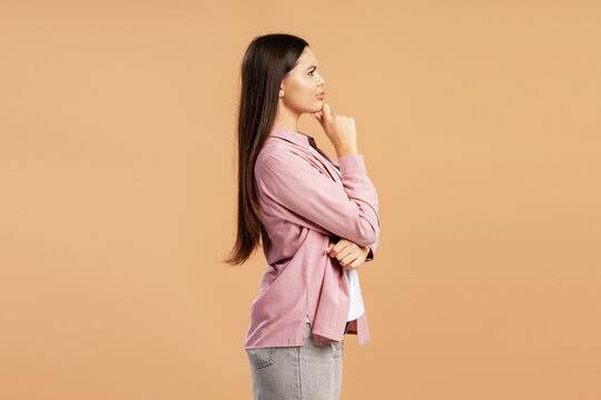 Young woman thinking, contemplating a decision, making a choice, having new ideas