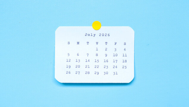 A paper sticker showing July 2026 placed on a blue background. A july 2026 sticker attached to a blue background. Minimal and clean calendar concept.