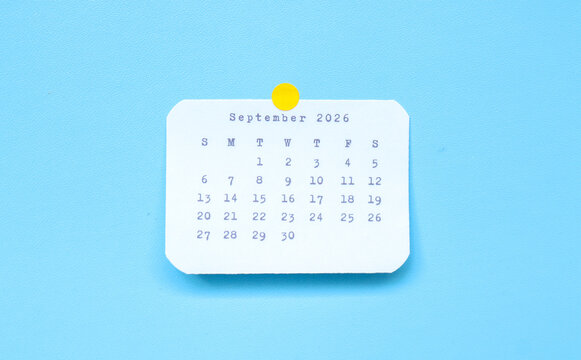 A paper sticker showing September 2026 placed on a blue background. September 2026 sticker attached to a blue background. Minimal and clean calendar concept.