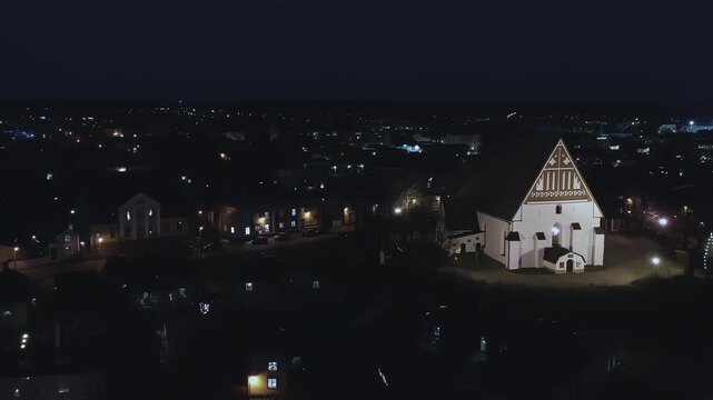 Porvoo.Finland-December 12.2020: Nighttime aerial shot of the Evangelical Lutheran Church in Porvoo Finland. Aerial shot with the drone slowly moving sideways.