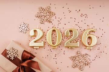 2026 golden number candles with gift box snowflakes and glitter confetti on pastel background flat...