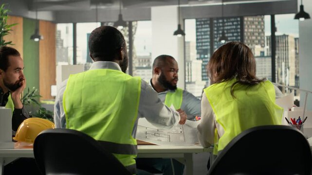 Group of diverse colleagues consulting on a master plan for urban development. Property developers reviewing architectural software to achieve real estate growth, innovation. Camera B.