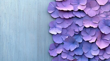 Close-up of a decorative arrangement of purple hydrangea flowers against a blue background, creating a visually appealing floral pattern.