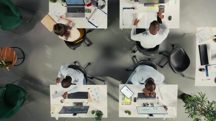 Top down view zoom in of diverse work team study analytics and forecasting, focus on performance metrics and report writing. Data visualization to support growth and management decisions. Camera A. - Powered by Adobe