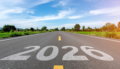 Open road stretching toward horizon with painted 2026 on asphalt under blue sky and scattered clouds, green fields and trees flanking highway conveying forward motion and optimism