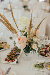 Wedding table decor with roses and dried grasses