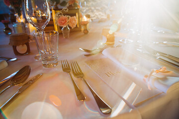 Wedding reception table setting with place card and sun flare