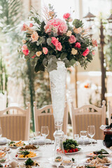 Wedding reception table setting with floral centerpiece decoration