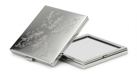 白い背景にきらめく銀色の高級感あふれる金属製小物入れ 蓋に施された繊細な唐草模様の彫刻が柔らかい光を美しく反射 半開きの状態から内部の光沢も覗かせ全体が上品に輝く. AI Generated