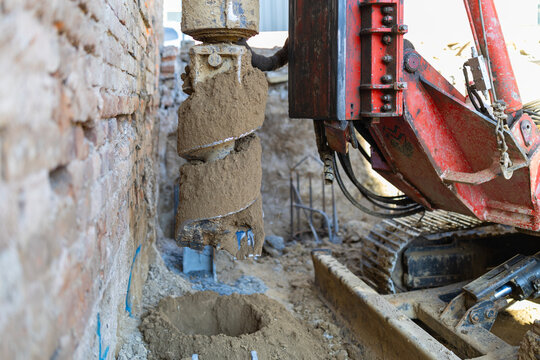 Heavy drilling machine creating building foundation piles