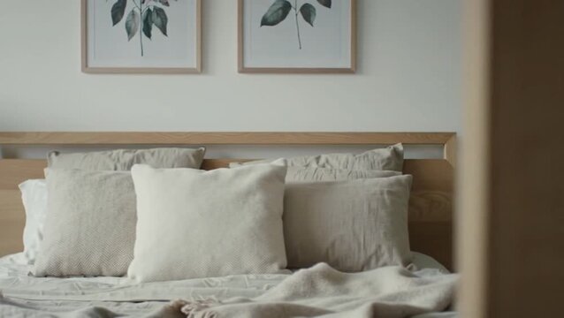 Minimalist bedroom with light wood bed frame and neutral bedding decor