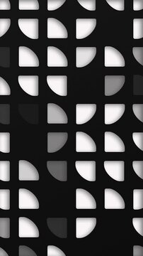 Black and white abstract background with an elegant pattern of quarter circle quadrant cutout shapes. This clean modern vertical design is full HD and a seamless loop.