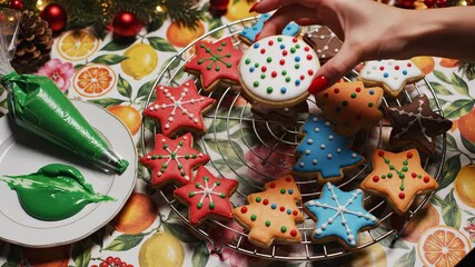 Festive baking video featuring colorful Christmas cookies being decorated with icing and holiday cheer for family fun christmas cooking overhead
