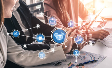 A business team collaborates on digital solutions in a modern office, showcasing ERP technology and communication icons, highlighting teamwork and innovation. Tessel