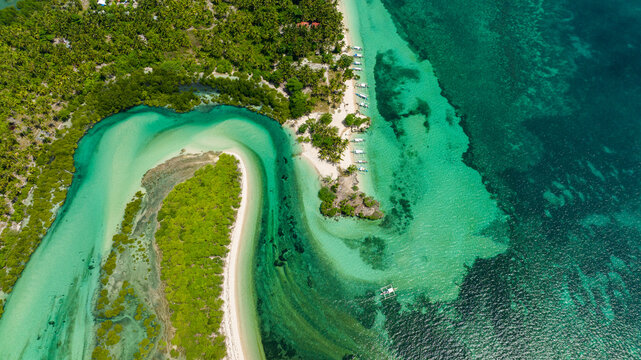Top view of blue lagoon with islands in turquoise water. Tropical landscape. Balidbid Lagoon, Bantayan island, Philippines.