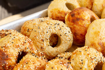 A view of a tray of assorted bagels.