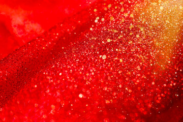 Festive New Year and Christmas Wallpaper.christmas mockup in red and gold tones.Red Fabric with Gold Glitter. Red glitter fabric folds and golden bokeh.