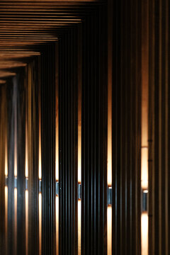 Parallel lights breaking out from a wood wall.