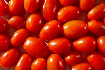 A top down view of a layer of grape tomatoes, as a background.
