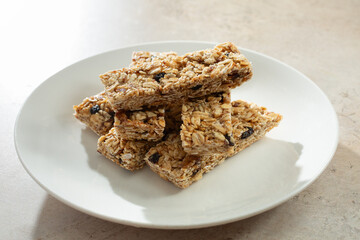 A view of a pile of granola bars, on a plate.