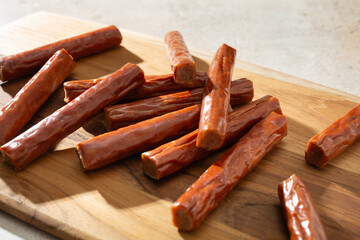 A closeup view of a pile of mini beef sticks.