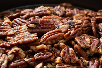 A closeup view of a pile of pecan halves.