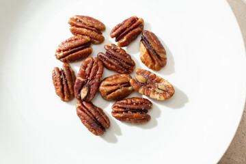 Obraz premium A top down view of a pile of pecan halves.