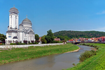 Sighisoara downtown with Holy Trinity Church on the river bank in Romania