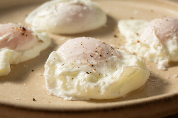 A closeup view of a plate of poached eggs.