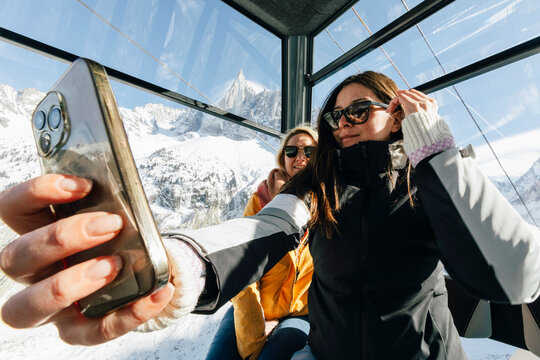 Sisters Taking Selfie in Cable Car Over Mont Blanc