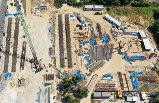 Aerial view of foundation work with stacked rebar and crane