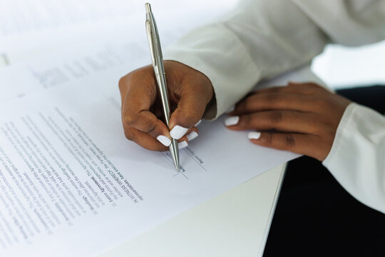 Close up of partial seller agent signature real estate agreement