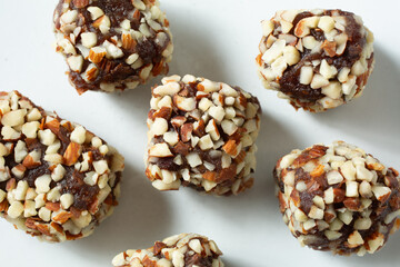 A top down view of some almond date rolls, on a plate.